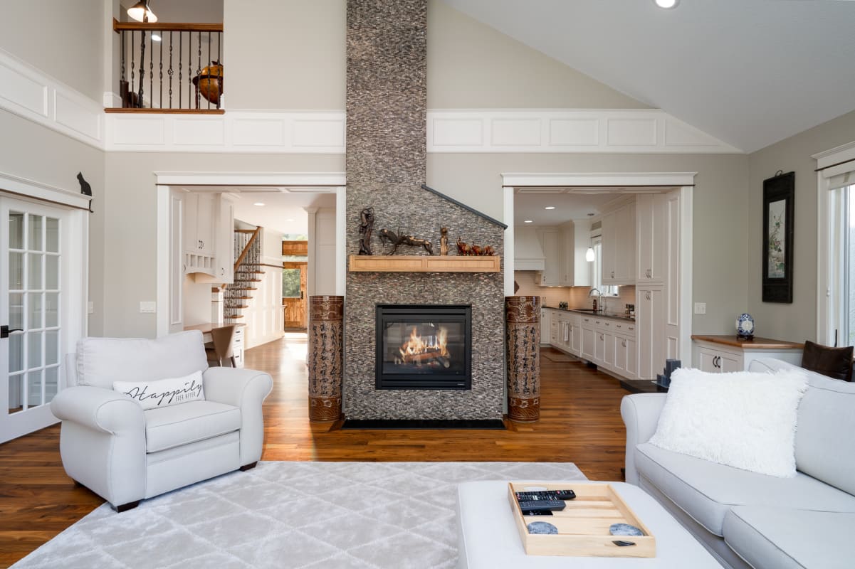 Sink into plush seating around your elegant stone fireplace, where warm flames create the perfect backdrop for memorable evenings together.