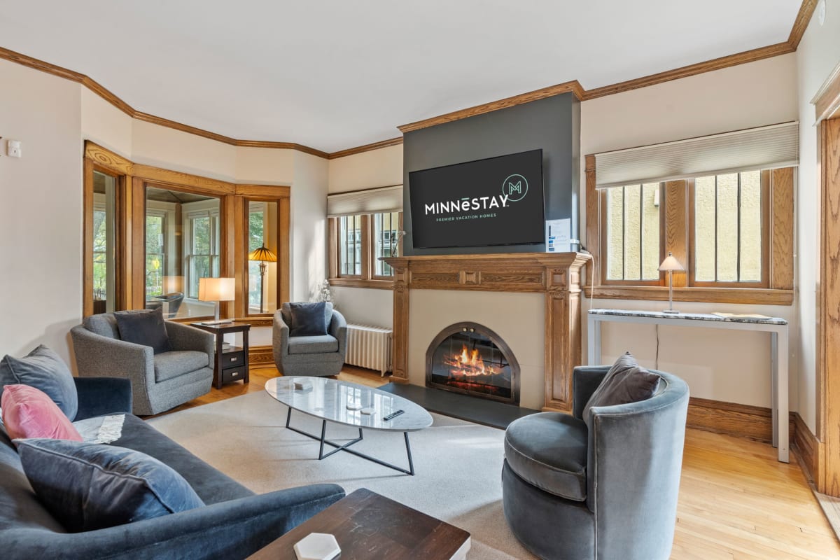 Sink into plush seating around your crackling fireplace, where rich wood details and natural light create the perfect spot to unwind.