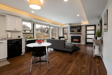 Interior view of a contemporary living space with kitchen, dining, and lounge areas.