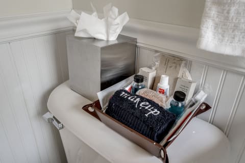 Bathroom view featuring personal care items on a toilet tank.