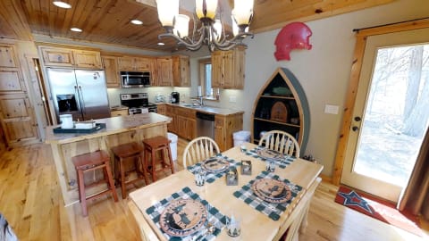 A rustic kitchen with wooden elements and a warm dining area.