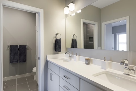 Interior view of a modern bathroom with a double sink and minimalist design.
