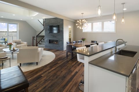 Modern open-concept living space with lounge, dining area, and kitchen bar.