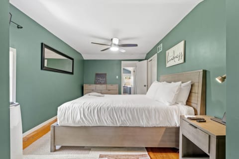 Cozy bedroom featuring green walls and contemporary furnishings.