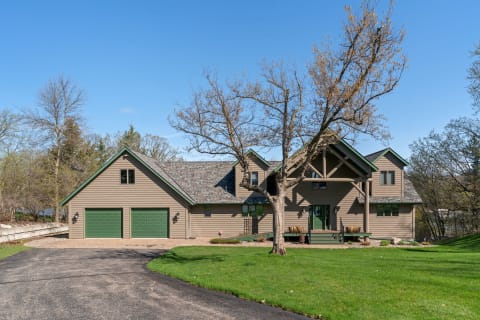Modern home with earthy tones and a well-maintained lawn.