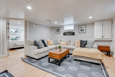 Inviting basement living room with a sectional sofa and decorative elements.