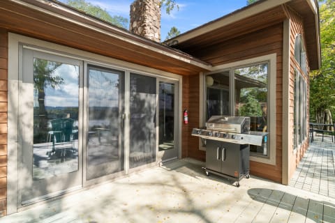 Cozy outdoor space with a grill and wooden deck.