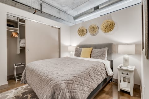 Cozy bedroom featuring a queen-sized bed and modern decor elements.