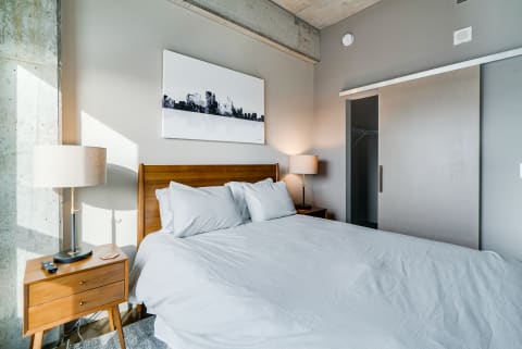 A cozy modern bedroom with a queen-sized bed and stylish furniture.