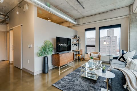 Urban apartment living room featuring modern decor and a large window.