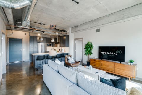 Contemporary apartment interior featuring a living room and kitchen area.