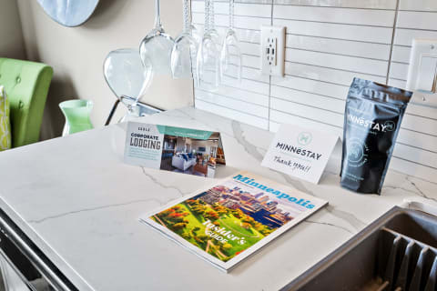 Kitchen countertop displaying corporate lodging brochures and a coffee package.