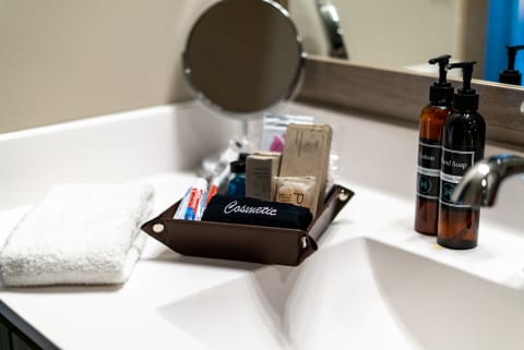 Organized bathroom countertop featuring a tray with cosmetics and toiletries.
