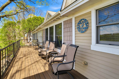 Stretch out on the spacious wraparound deck, where comfortable seating invites you to soak in sunshine and fresh air. Surrounded by lush spring foliage and serene treetop views, it's your perfect spot for morning coffee or peaceful evenings outdoors.