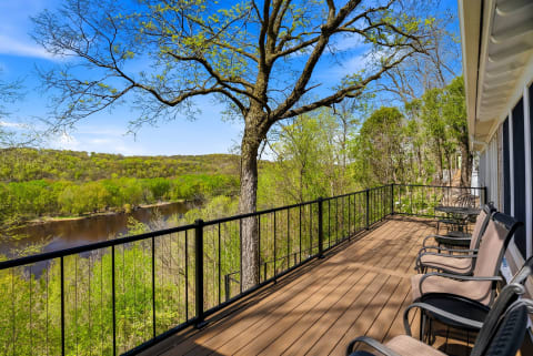 Settle into your riverside deck and watch spring unfold—lush green trees, sparkling water, and peaceful views stretch before you. Perfect for morning coffee or sunset relaxation.