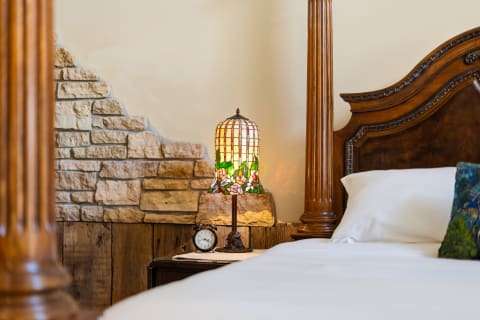 Sink into crisp linens and rustic charm as natural stone walls and warm wood details create your peaceful retreat for restful nights.