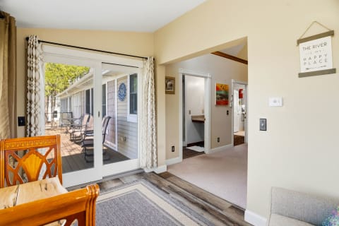 Step into your serene escape with warm tones, thoughtful décor, and easy access to a private outdoor deck where relaxation awaits.