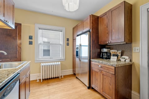 Warm wood kitchen with stainless steel appliances and a cozy atmosphere.