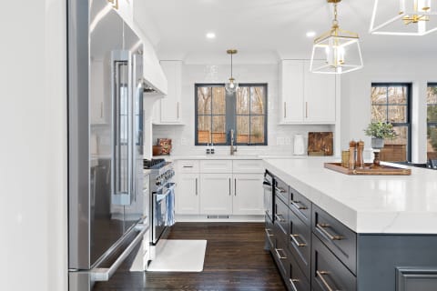 Modern kitchen featuring a marble countertop island and sleek cabinetry.