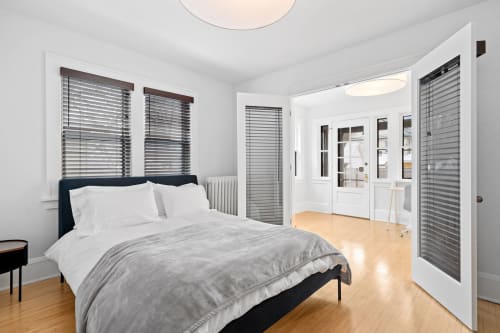 Rest peacefully in your bright bedroom with crisp linens, warm hardwood floors, and privacy blinds for your perfect sleep sanctuary.