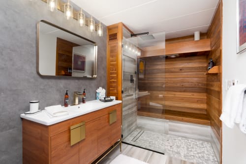 Indulge in your private spa sanctuary with a stunning wood-lined sauna and luxurious rainfall shower after your memorable day.