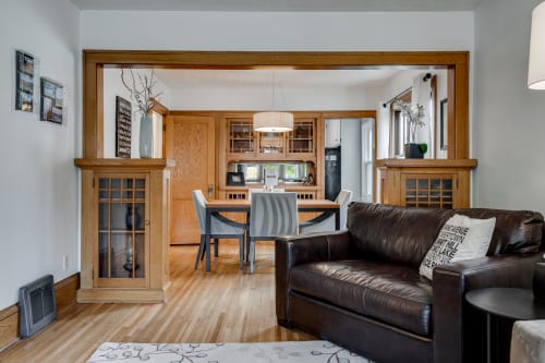 Relax on your leather sofa while enjoying the open flow to your fully equipped kitchen with rich wood details.
