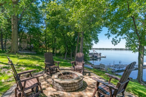 Gather around the fire pit with stunning lake views stretching before you—your perfect spot for evening conversations and peaceful moments.