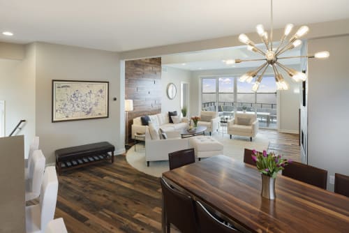 Relax in your stylish open-concept living space with contemporary furnishings, stunning sputnik chandelier, and private balcony access.