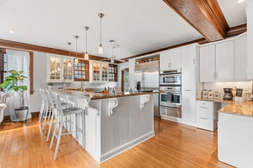 Your gourmet kitchen features stunning exposed beams, spacious island seating, and premium appliances for memorable meal preparations.