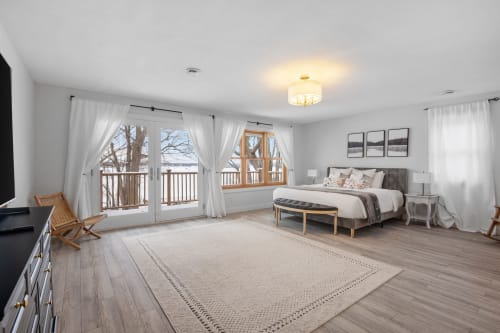 Wake up in this serene master suite with French doors opening to your private balcony and nature views beyond.