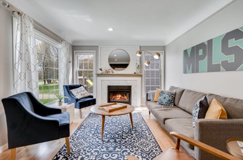 Sink into plush seating by your cozy fireplace, where stylish decor and warm ambiance create the perfect retreat for relaxation.