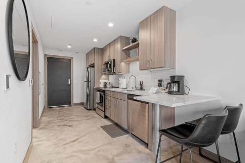 Your modern kitchen awaits with sleek wood cabinetry, marble countertops, and premium appliances for memorable meal prep.