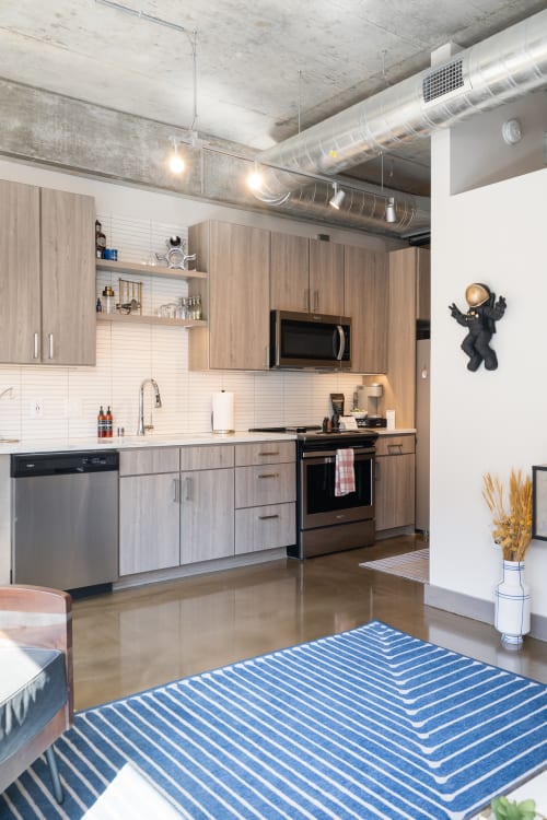 Your modern kitchen features sleek wood cabinets, stainless appliances, and stylish industrial touches for effortless cooking.