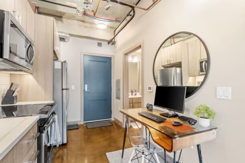 Your modern loft features exposed ceilings, a fully equipped kitchen, and stylish workspace perfect for both cooking and productivity.
