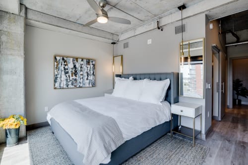 Unwind in this industrial-chic bedroom where exposed concrete meets plush comfort. Fresh linens and city views create your perfect urban retreat.