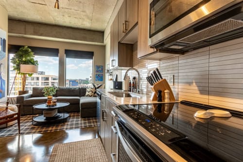 Your fully equipped kitchen flows seamlessly into the cozy living space, perfect for preparing meals while enjoying city views.