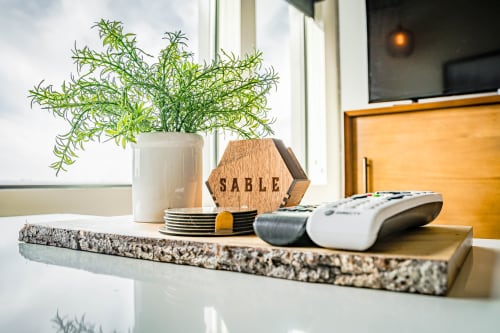 Relax in your stylishly appointed kitchen where modern granite meets warm wood accents and fresh greenery brightens your cooking space.