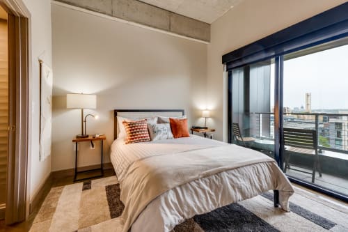 Wake up to city views from your stylish bedroom, featuring crisp linens and warm industrial touches that create the perfect urban retreat.