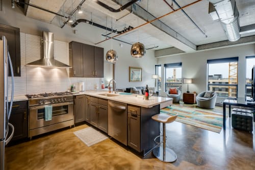 Your modern loft kitchen features sleek appliances and industrial charm, perfect for cooking memorable meals with city views.
