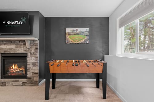 Challenge friends to foosball by your cozy fireplace, where competitive games and warm conversations create perfect vacation memories.