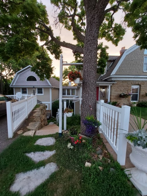 Charming property with beautiful gardens and mature trees creating a peaceful residential setting.