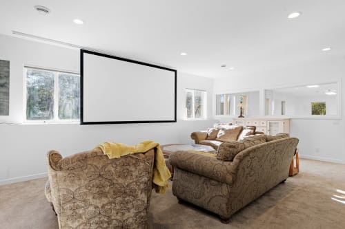 Settle into plush seating for your personal movie theater experience, complete with a massive projection screen.