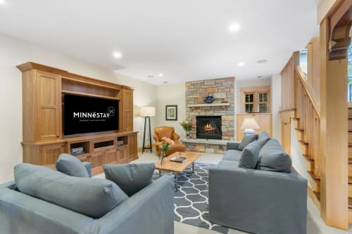 Sink into plush seating while the fireplace crackles warmly. Your entertainment hub features surround sound and a large screen for cozy movie nights.