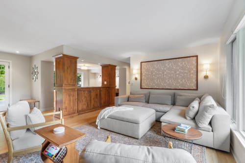 Sink into plush sectional seating where natural light streams through large windows, creating your perfect retreat for relaxation.